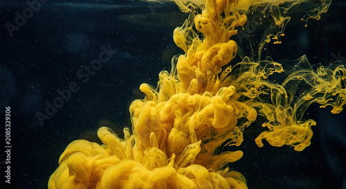Yellow Ink Swirling Slowly In Dark Clear Water