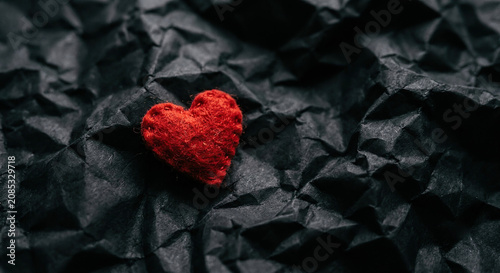 Small Red Felt Heart on Crumpled Black Textured Surface
