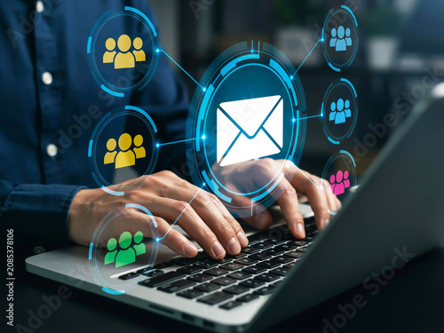 Professional businessman using laptop with digital email and networking interface for global communication