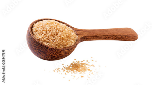 Foto Wooden spoon filled with brown sugar crystals