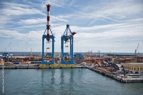 Industrial Cargo Port with Large Cranes and Shipping Containers.