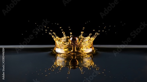 Oil drop hitting liquid showcasing modern professional aesthetic detailed macro photography
