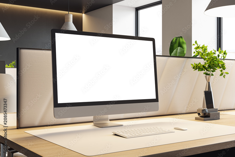 Fototapeta premium Modern office workspace featuring large blank computer monitor on clean desk within contemporary design interior and soft natural lighting background. 3D Rendering