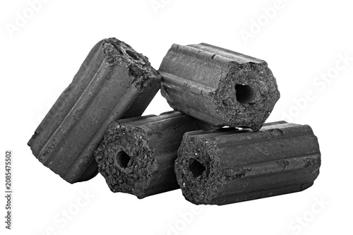 Foto Black charcoal briquettes are arranged on a white background with clipping path