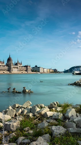 Budapest skyline panorama time lapse with the Hungarian Parliament Building and rushing clouds over the Danube River on a sunny day