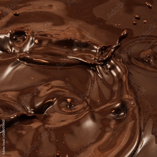 Abstract chocolate liquid surface with glossy texture and ripples, dark cocoa square background
