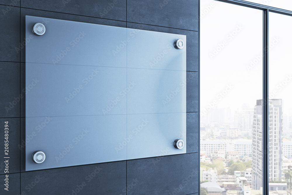 Obraz premium Empty modern interior with large blank glass sign mounted on dark wall beside bright city view window in contemporary business corridor. 3D Rendering