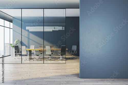 Modern corporate meeting room behind glass walls with empty blue wall foreground as clean mockup space for design templates. 3D Rendering