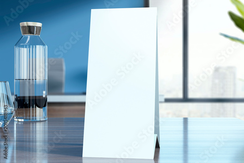 Blank tabletop tent card mockup standing on a clean modern office desk with g...