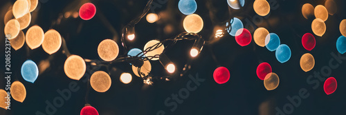 Close-up of colorful bokeh lights on dark background in festive mood