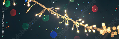 Close-up of a sparkling Christmas light string on dark background