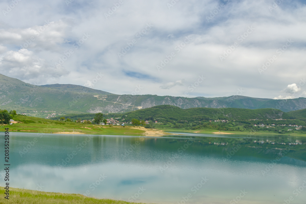 Obraz premium Tranquil Scenery at Rama Lake With Lush Green Mountains and Reflective Blue Water Atmosphere