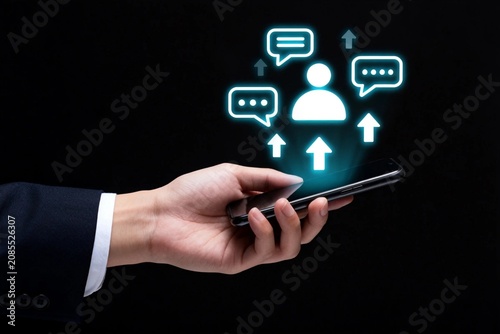 Business hand holding smartphone with digital communication icons