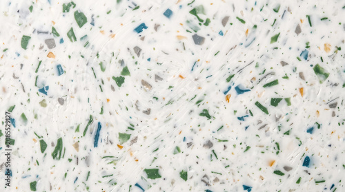 Abstract background texture of compressed white recycled plastic composite panel with colorful flecks
