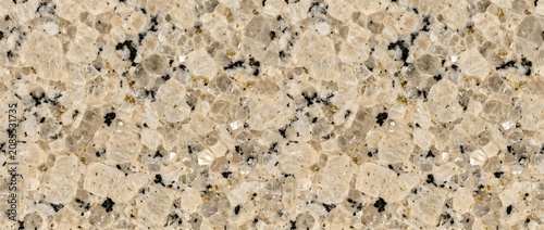Foto Beige granite texture reveals a creamy champagne stone surface dotted with tiny