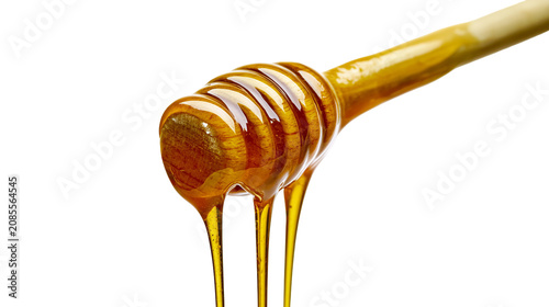 Fotografía Golden honey dripping from wooden dipper