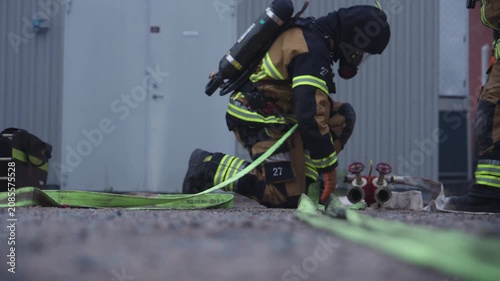 Firefighters Deploying Hose Line During Emergency Response