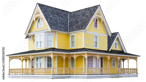 Victorian yellow house with wrap-around porch and ornate trim