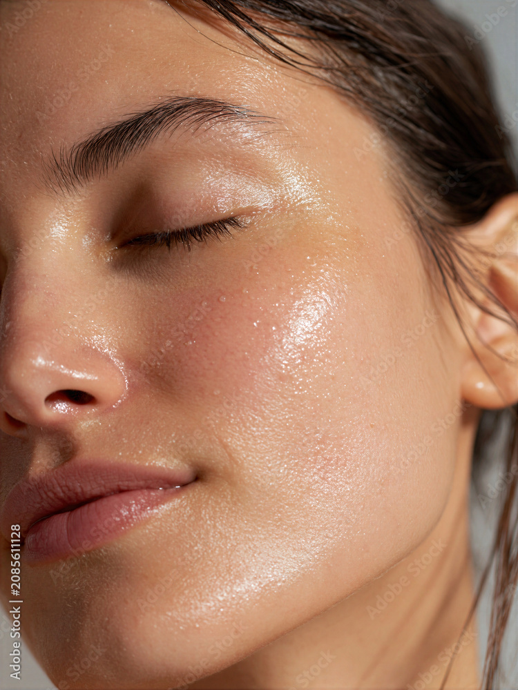 Fototapeta premium Close-up of a woman with glowing skin during a morning skincare routine