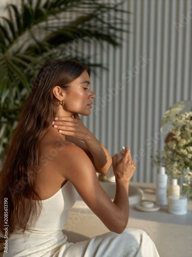 Woman applying skincare product during morning ritual