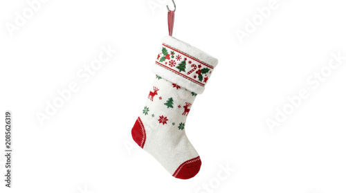 A white christmas stocking with red and green decorations hangs from a ribbon.