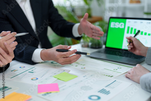 Business people discussing ESG strategy and sustainability data during a meeting