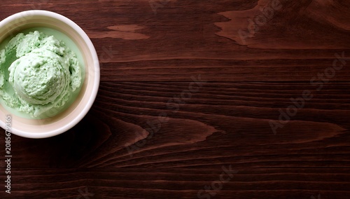 Refreshing Mint Ice Cream in a Bowl on a Dark Wooden Table.