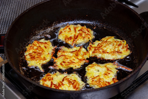 potato pancakes are fried in a frying pan