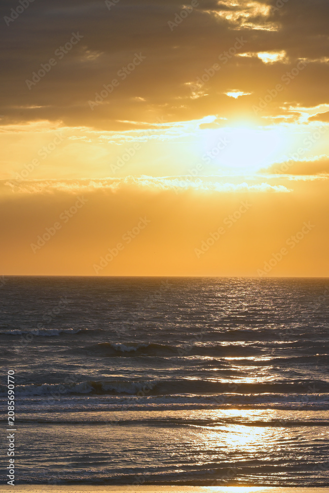 Fototapeta premium Golden clouds at Zandvoort during sunset, with soft warm tones and textured sky gradients ideal for calm atmospheric designs.
