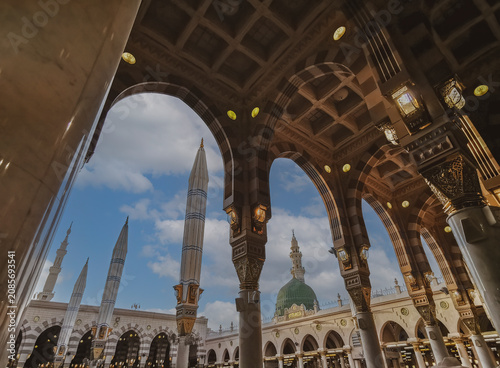 General view green dome and Moorish pattern arches of Nabawi mosque in Al Madinah, Kingdom of Saudi Arabia.