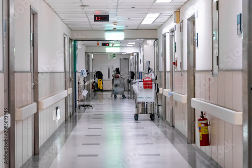 Konstfotografi A nurse pushes a medical trolley through a bright hospital corridor, transporting medications and clinical supplies for patient care
