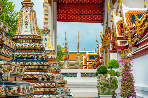 Ornate buddhist architecture at Wat Pho temple with colorful chedis, traditional design and sacred cultural heritage in Bangkok city, Thailand, Asia. Temple of the Reclining Buddha