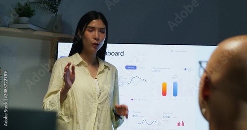 A businesswoman and colleague collaborate on marketing and investment plans to expand the business.