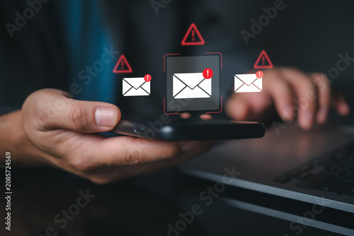 Foto Close up of hands using mobile phone displaying suspicious email notification icons