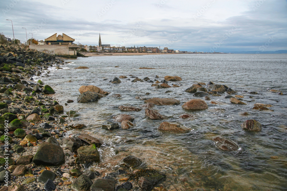 Fototapeta premium East end of Portobello beach in Edinburgh, overcast autumn day, Joppa parish church tower visible at distance