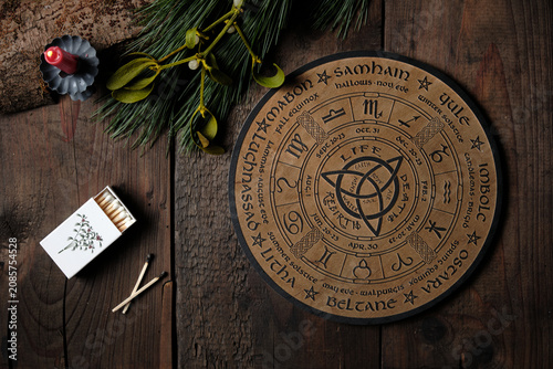 Tableau sur toile Overhead view of a wooden Wheel of the Year engraved with the eight pagan festivals