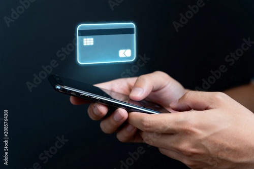 Hands using smartphone with glowing credit card icon