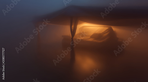 Glowing canopy bed warm light foggy atmosphere dreamy bedroom sheer curtain soft mattress ambient night illuminated bedding low contrast