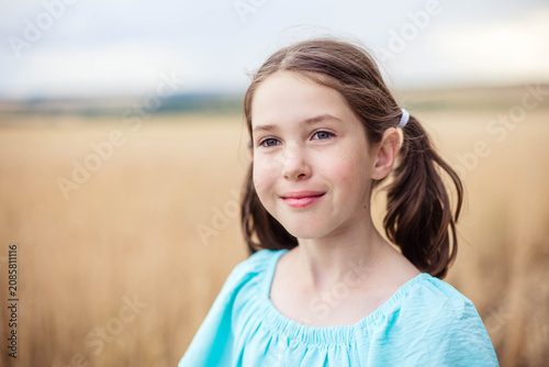 Cute girl close-up outdoors in summer, copy space