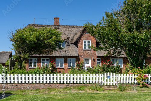 Traditional thatched-roof brick house on Langeneß Hallig in Germany