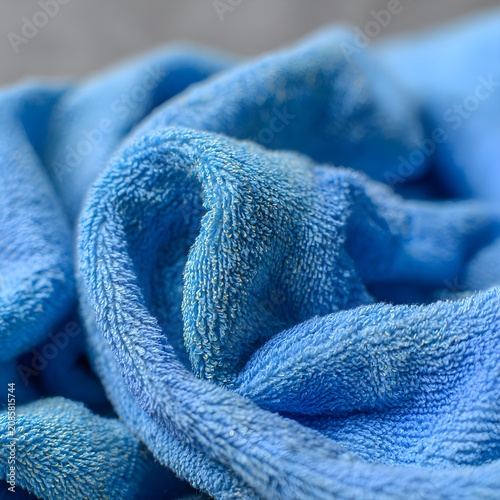 Soft blue microfiber cloth with golden glitter texture close up
