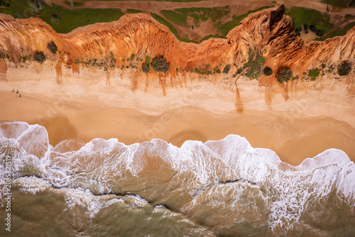 Tableau sur toile Praia da Falesia Aerial Drone Waves Foam Sandy Beach Red Cliffs Algarve Portugal