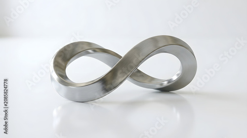 A shiny metal infinity symbol sits on a reflective white surface with a subtle shadow.