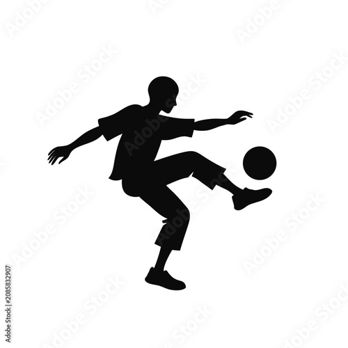 A football player is kicking the ball into the goal.