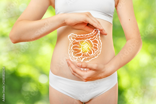 A teenage girl in white underwear against a natural background, with an intestinal projection. Sports and proper nutrition for health and longevity. Healthy lifestyle.