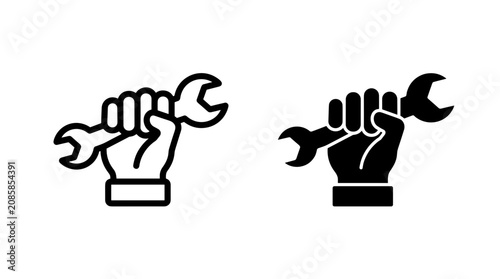 A set of two icons depicting a hand holding a wrench, one in outline and one in silhouette.