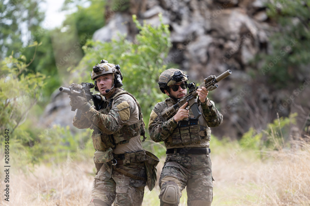 Fototapeta premium Military participate in a patrol in forrest terrain