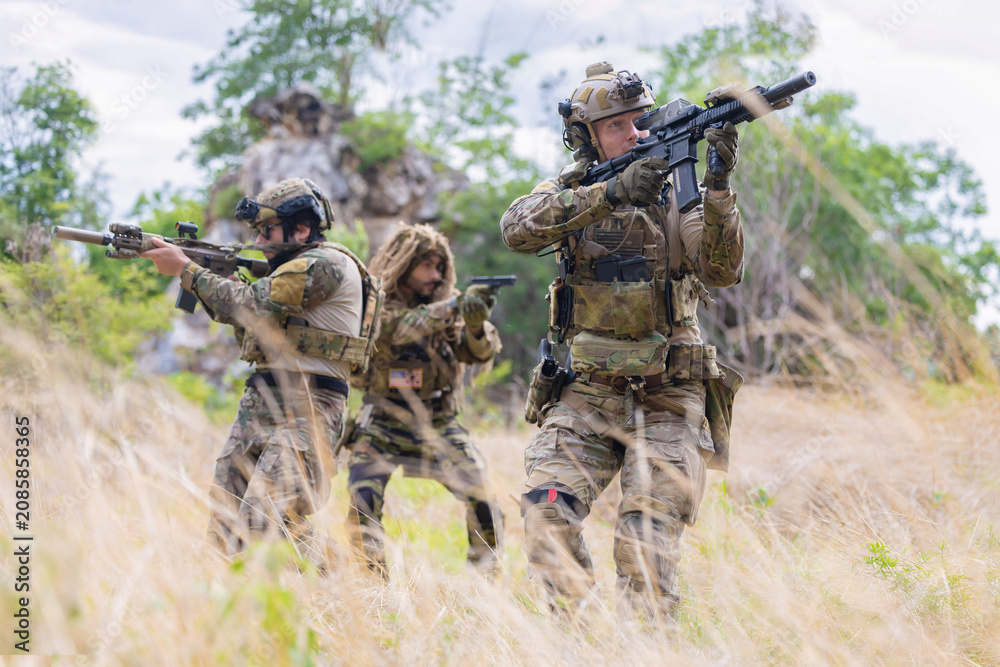 Fototapeta premium Military participate in a patrol in forrest terrain