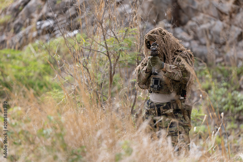 Fototapeta premium Military participate in a patrol in a rocky terrain