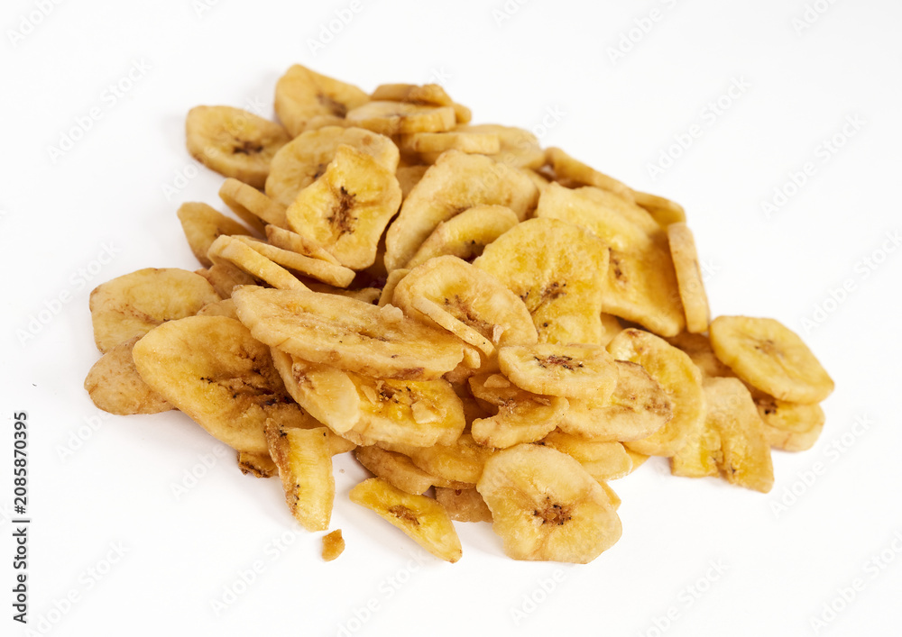Fototapeta premium Pile of crispy dried banana chips isolated on white background 